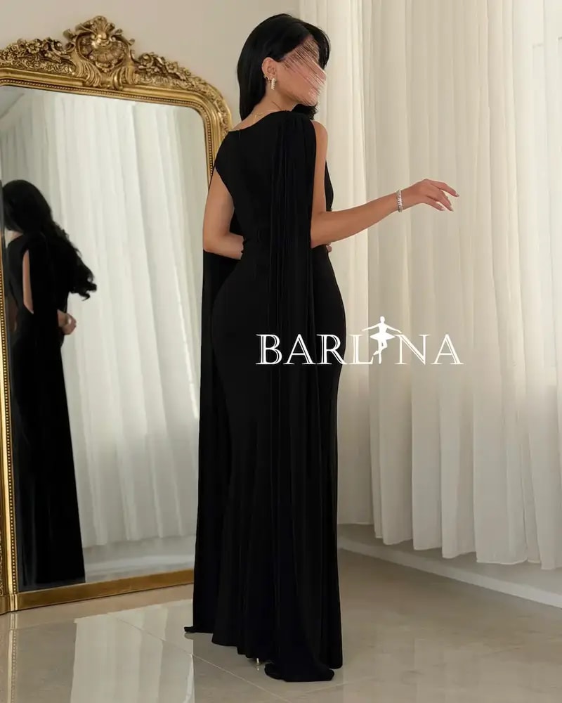 A soft black dress with a luxurious side sash.