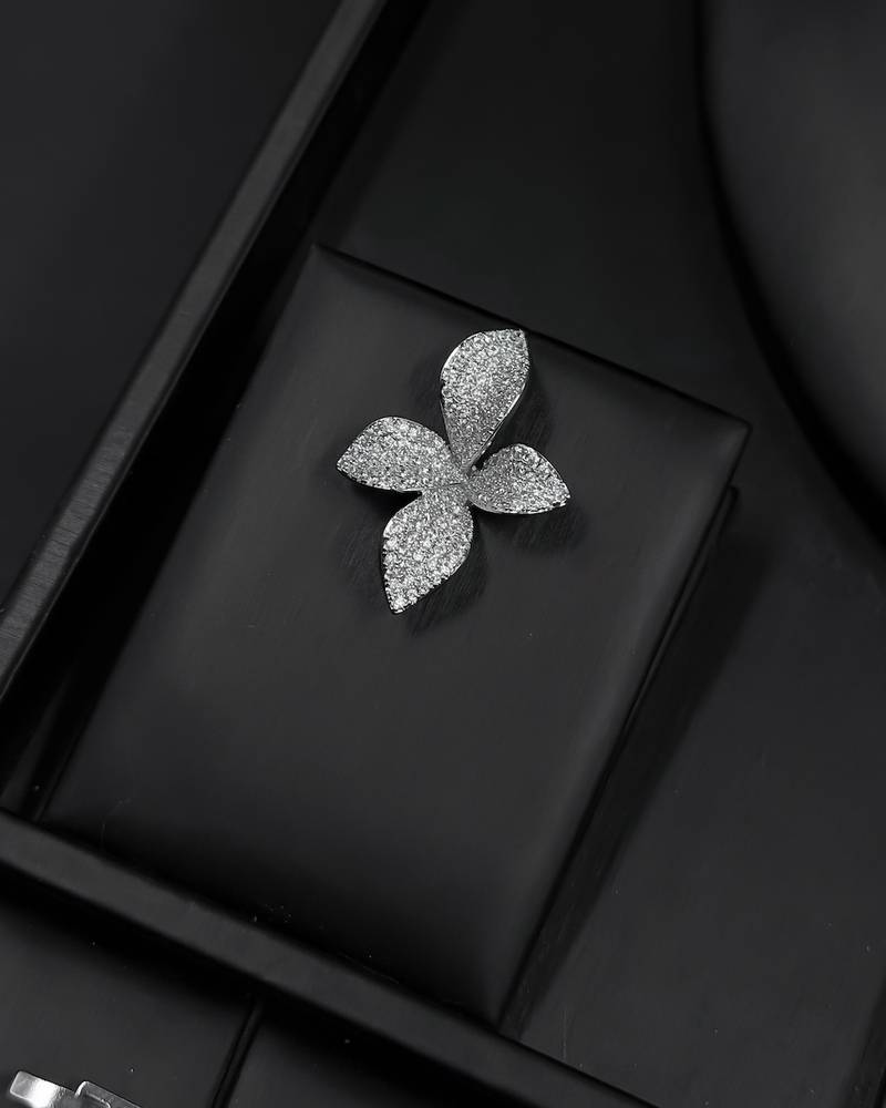 Silver accessory set with a four-petaled flower design