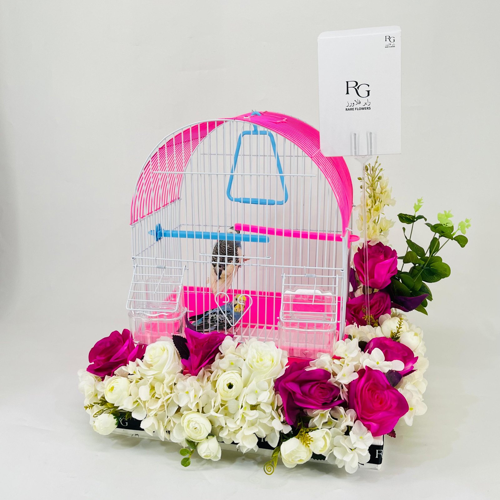 A pair of budgies with a cage decorated with colorful artificial flowers.04-code 14 - Image 3