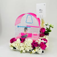 A pair of budgies with a cage decorated with colorful artificial flowers.04-code 14 - Image 3