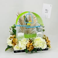 A pair of love birds with a cage decorated with colorful artificial flowers.01 - Image 2
