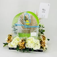 A pair of love birds with a cage decorated with colorful artificial flowers.01 - Image 3