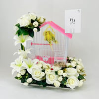 A pair of love birds with a cage decorated with colorful artificial flowers - Image 3