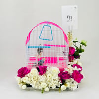 A pair of budgies with a cage decorated with colorful artificial flowers.04-code 14 - Image 1