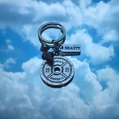 ميدالية مفاتيح مع عبارة تحفيزية "Beauty"