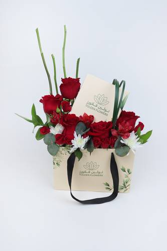A box arranged with red roses and Tulin chocolates