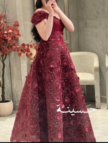 فستان عنّابي مطرّز بالورود