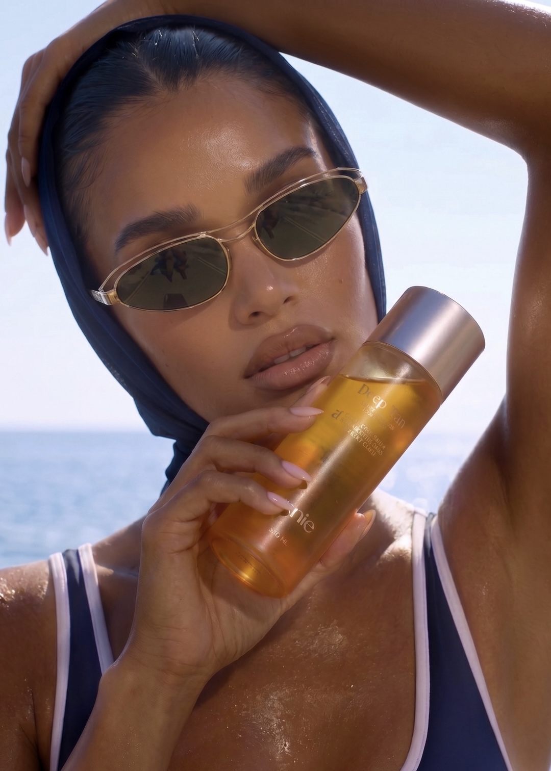 Model using Amie Deep Tan oil for a glowing bronzed summer look