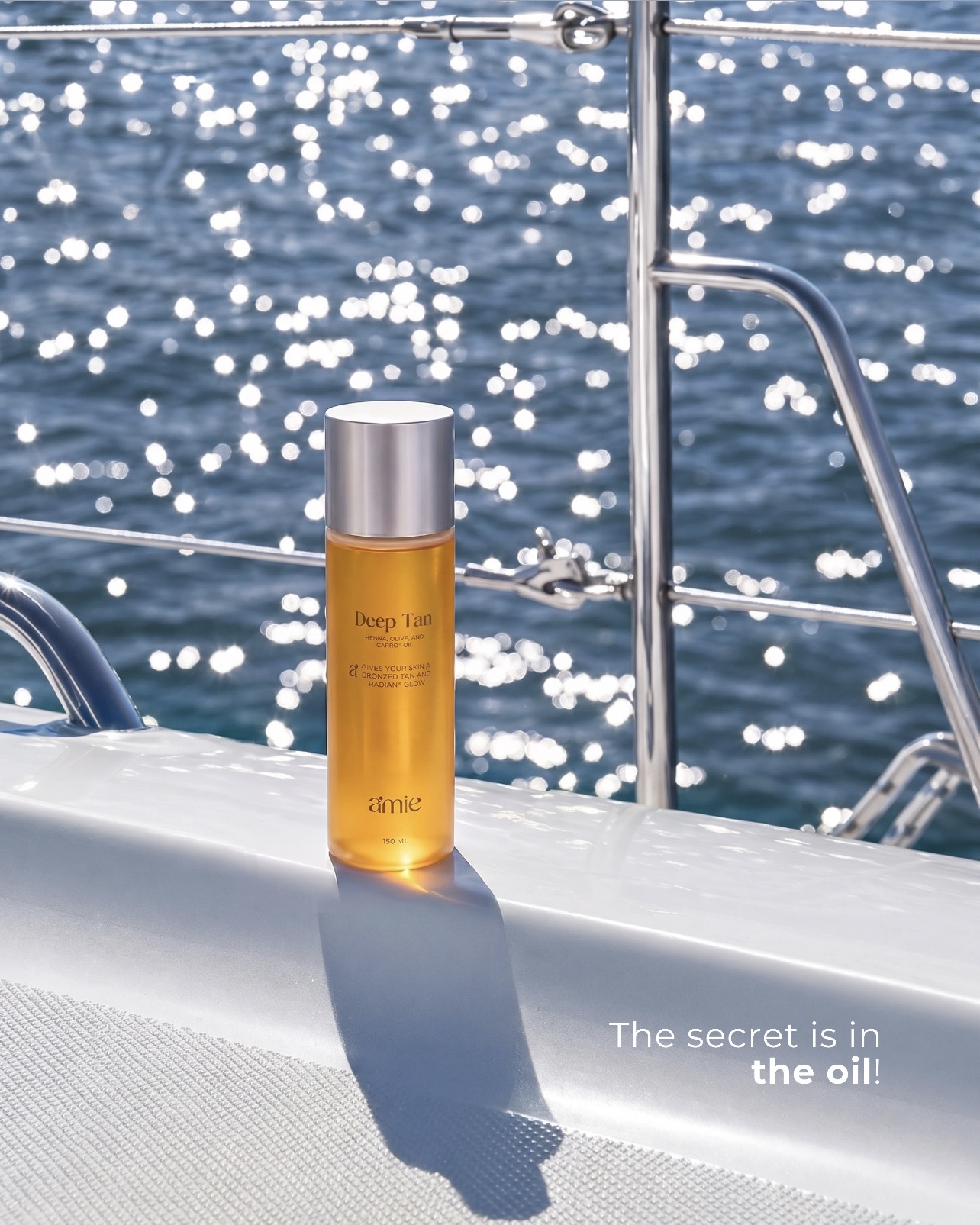 Amie Deep Tan tanning oil with a luxury summer ocean background