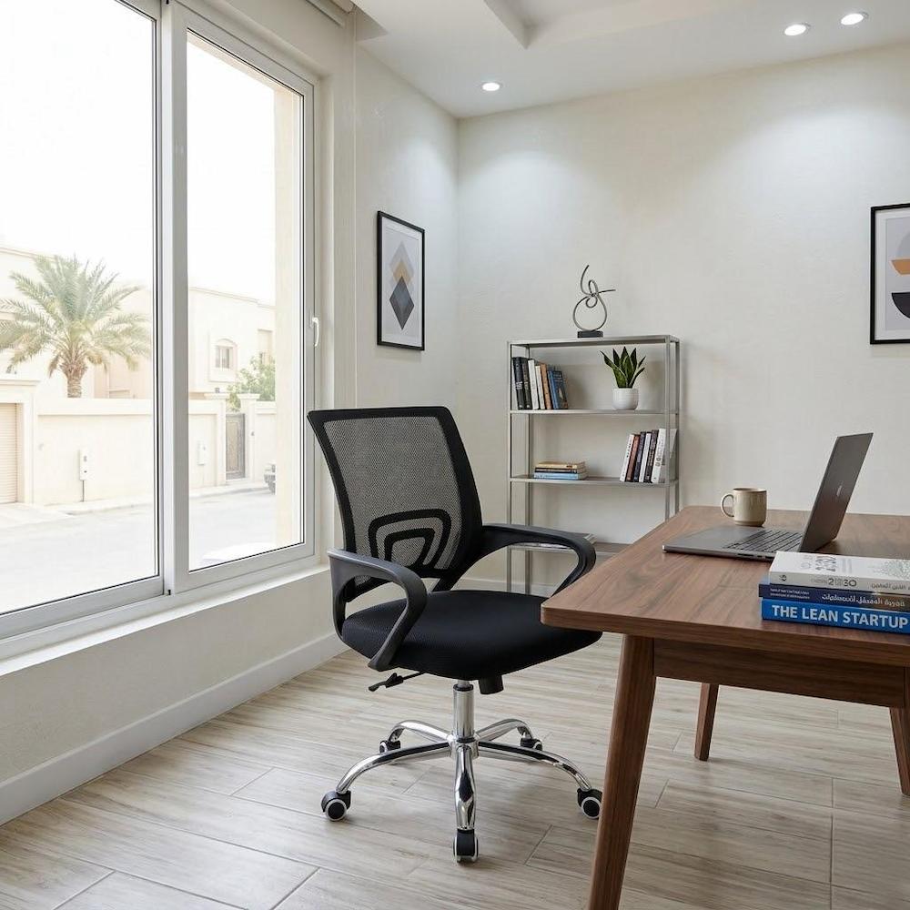 Black mesh office chair in a modern home office setting 