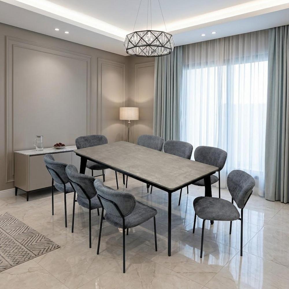  Dining table with 8 gray fabric chairs in modern dining room 