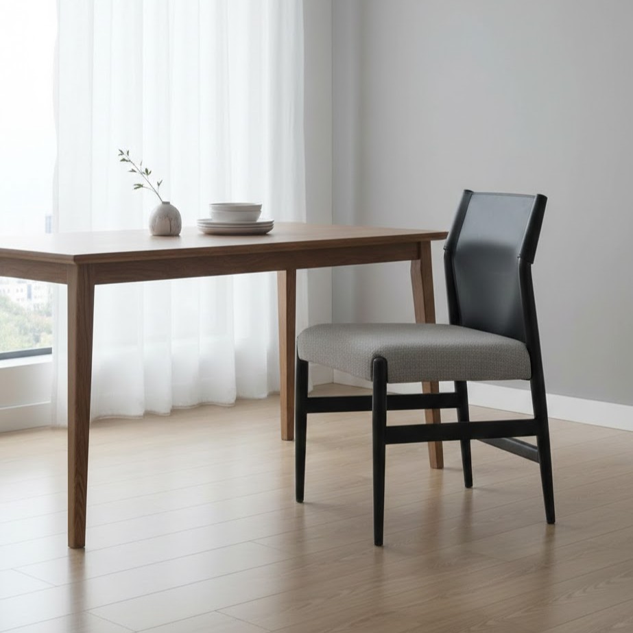  Black back dining chair with gray seat beside table 
