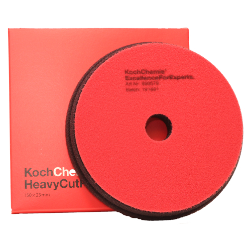 A round red polishing sponge with a hole in the center, placed in front of a square red cardboard box