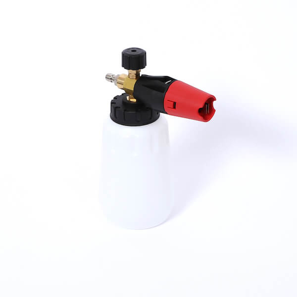 A white plastic bottle with a brass nozzle and a red and black spray head