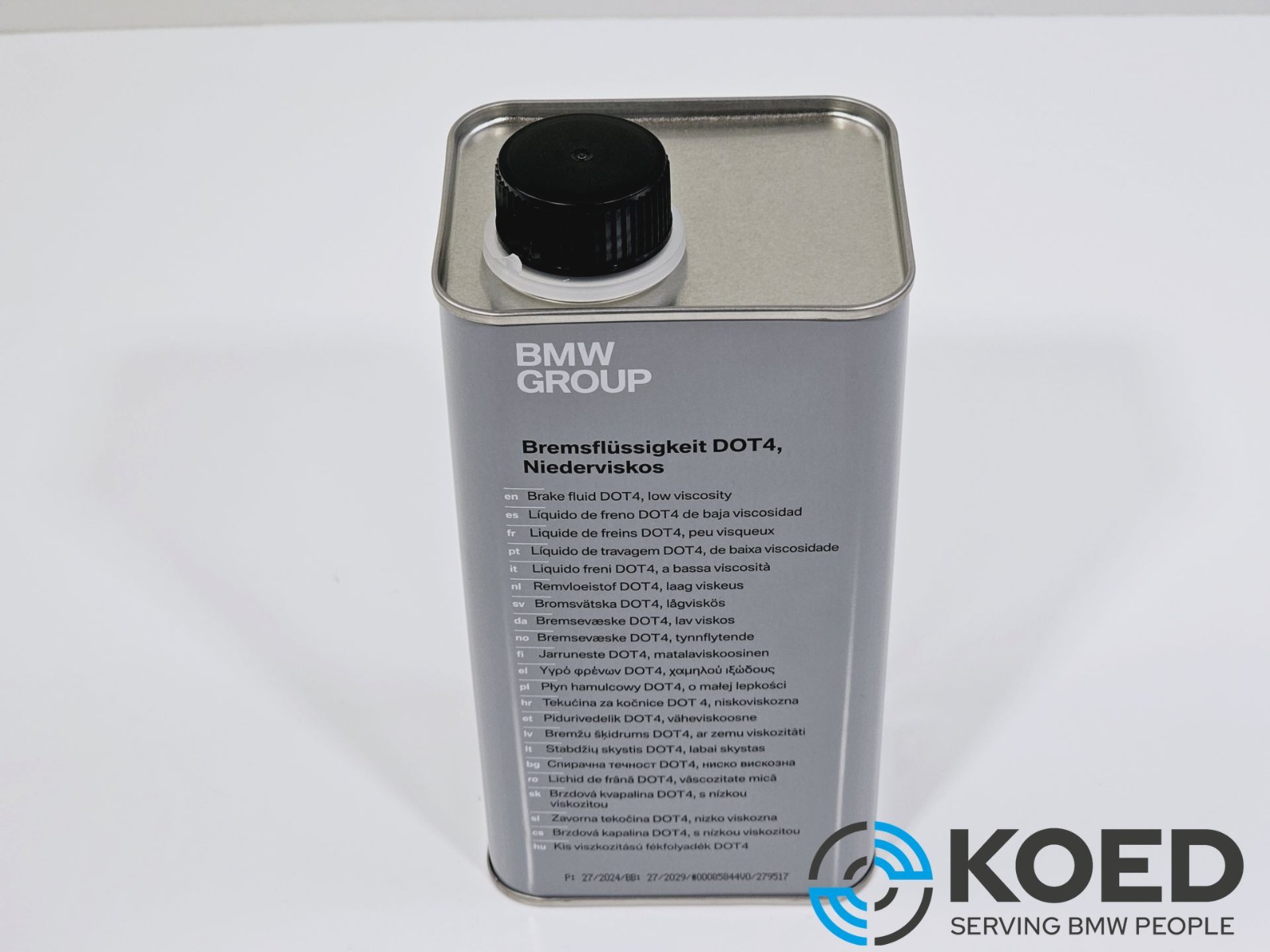 A rectangular silver metal can with a black cap of Genuine BMW Group Brake Fluid DOT 4 1000ml