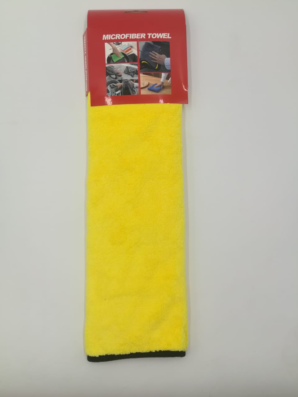 A yellow high-quality microfiber cleaning and polishing towel with black edges