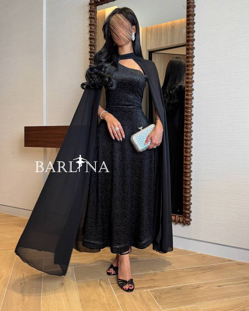 Elegant black dress with a draped chiffon cape