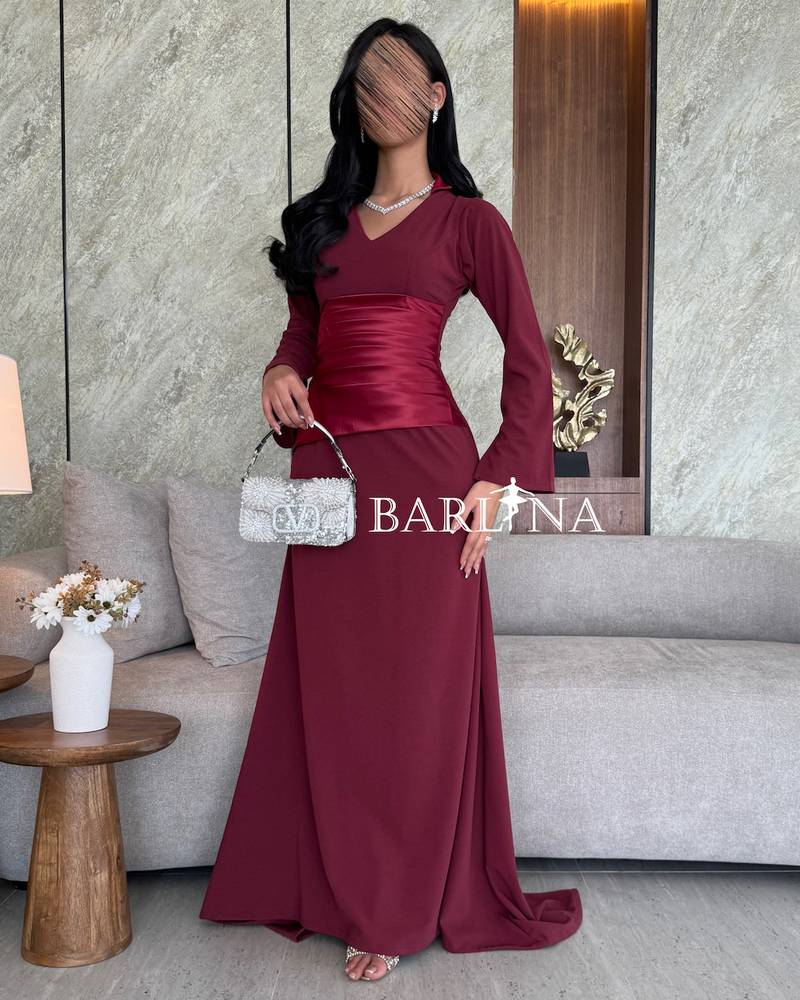 Burgundy dress with a narrow waist and long sleeves