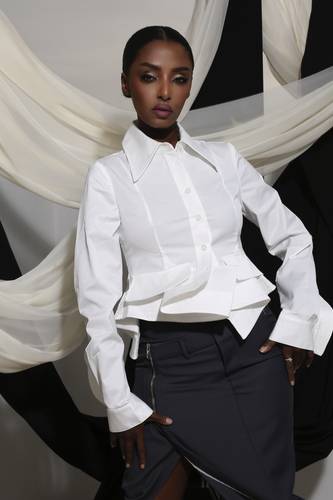 White shirt with large sleeves, jacket, and thigh-high zip skirt
