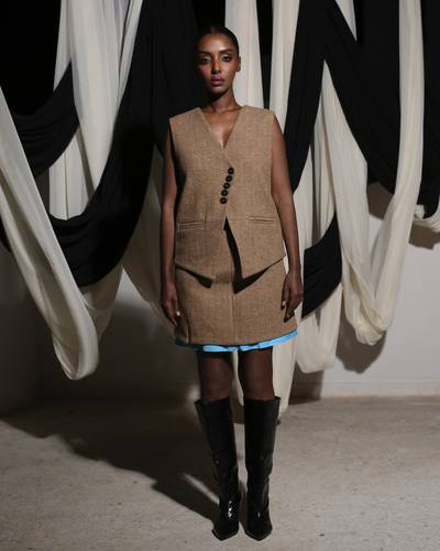 Brown jacket, skirt, and vest with light blue accents