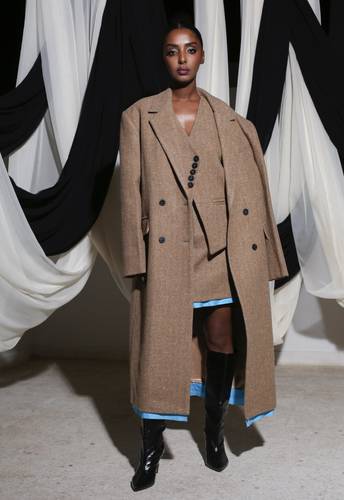 Brown jacket, skirt, and vest with light blue accents