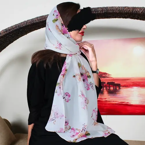 A soft scarf on a beige color with beautiful roses
