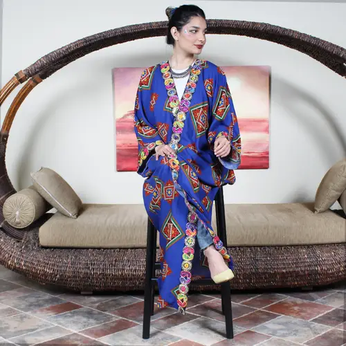 A bright blue bisht with decorative edges