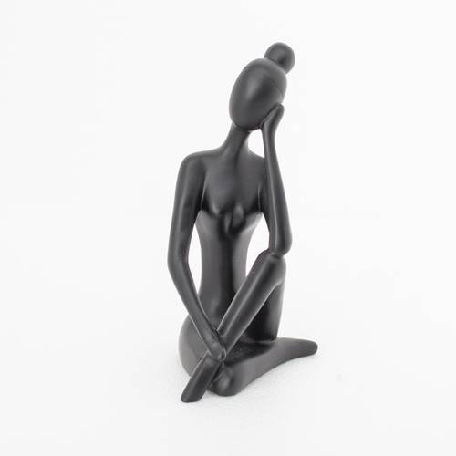 Abstract sculpture of a thinking person in black
