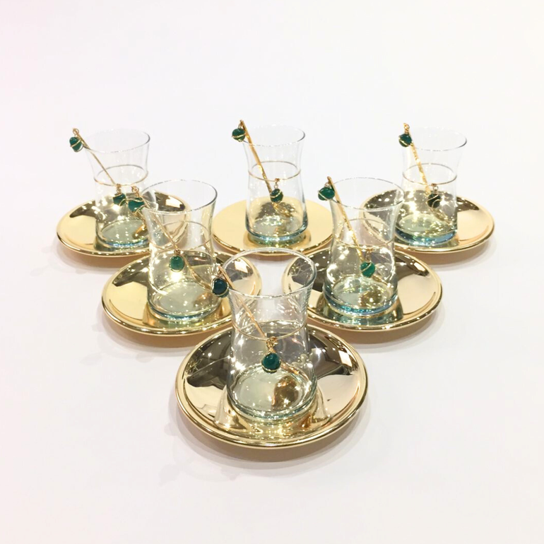 Gold plated tea set with green precious small stones