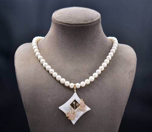 Diamond and shell pendant