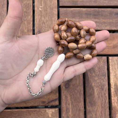 كوك طبيعية (خامة طبيعية) عدد الخرز 33 مقاس 10*14ملي بكركوشة حديد ما تصميمنا وتنفيذنا 