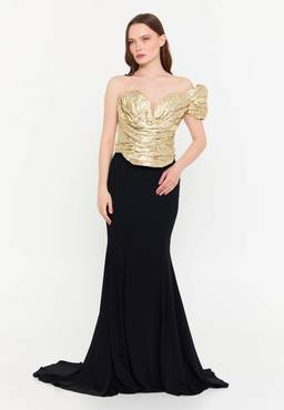 Woman in elegant gold and black gown