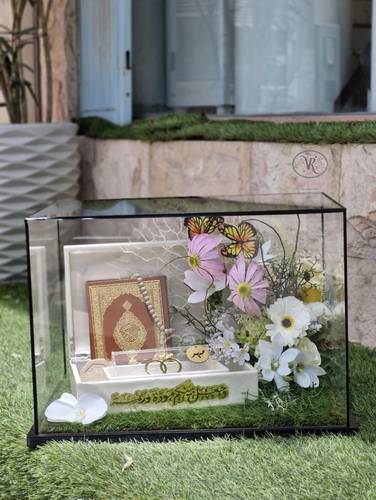 Glass dowry box with artificial flowers