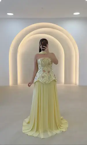 فستان سهرة أصفر باستيل فاخر بتصميم كورسيه مطرّز وتنورة شيفون واسعة
